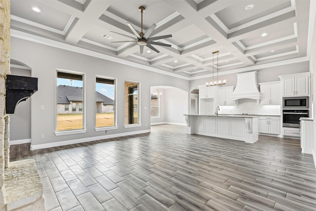 kitchen with white cabinets, tasteful backsplash, light hardwood / wood-style floors, custom range hood, and stainless steel appliances