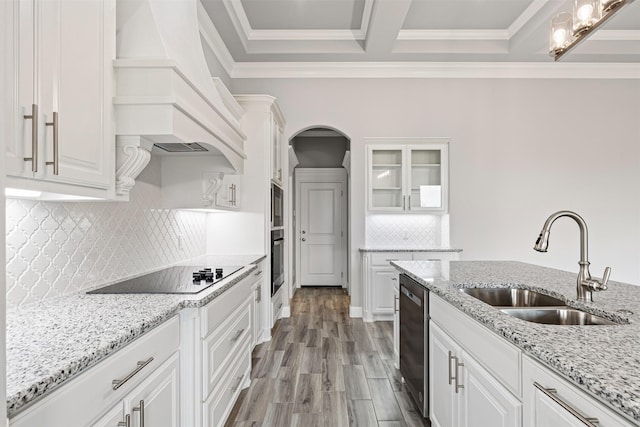 kitchen featuring custom exhaust hood, white cabinetry, and sink