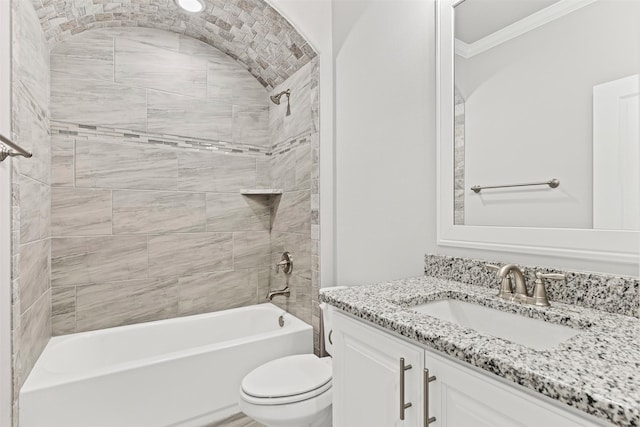 full bathroom with crown molding, vanity, tiled shower / bath combo, and toilet