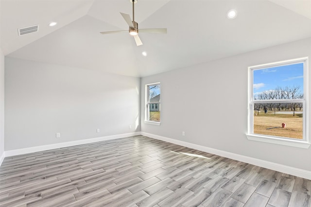 spare room featuring ceiling fan, light hardwood / wood-style floors, and vaulted ceiling