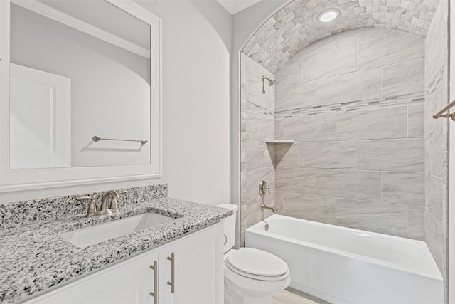 full bathroom with tiled shower / bath combo, toilet, and vanity