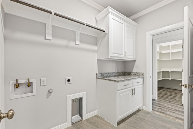 washroom with cabinets, light wood-type flooring, gas dryer hookup, crown molding, and electric dryer hookup