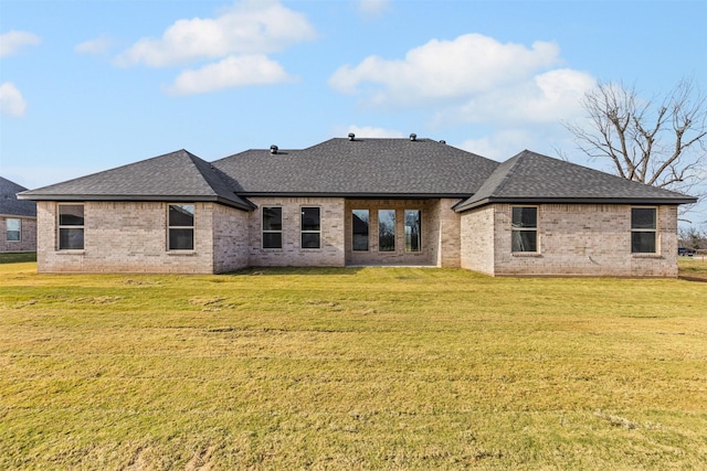 rear view of property with a yard