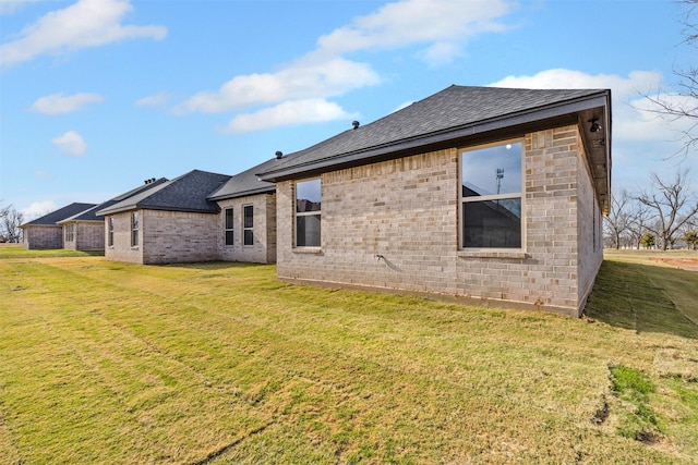 rear view of property featuring a lawn