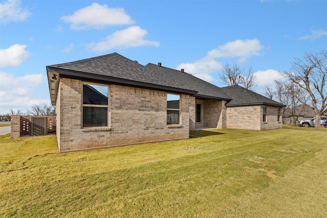 rear view of property featuring a lawn