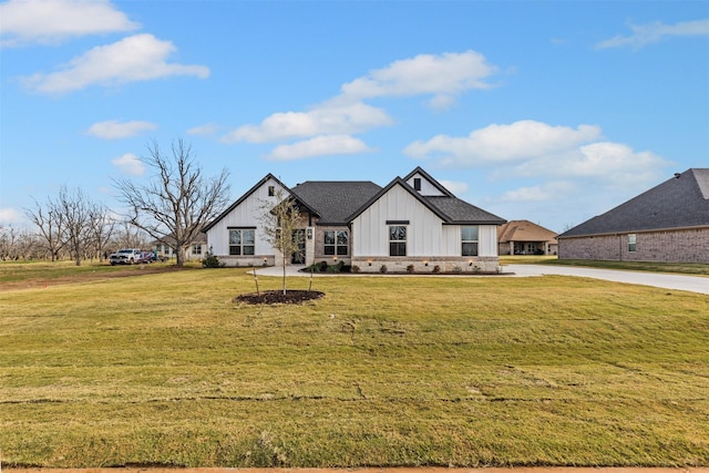 modern farmhouse style home with a front lawn