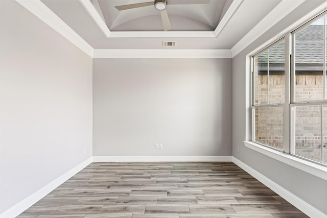 empty room with crown molding, light hardwood / wood-style flooring, and a healthy amount of sunlight