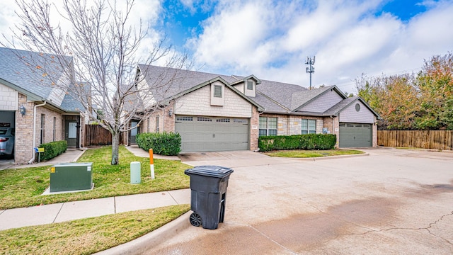 view of front of home with a garage and a front lawn