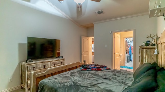 bedroom with ceiling fan, a spacious closet, and ornamental molding