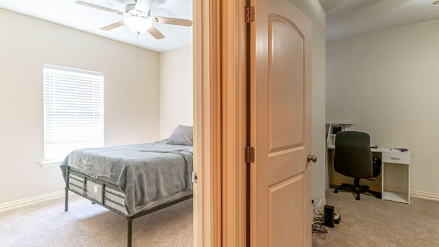 bedroom featuring ceiling fan and light carpet