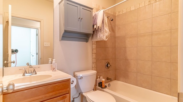 full bathroom featuring vanity, toilet, and tiled shower / bath