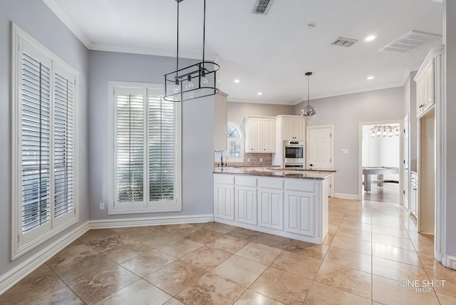 kitchen with white cabinetry, ornamental molding, kitchen peninsula, and pendant lighting