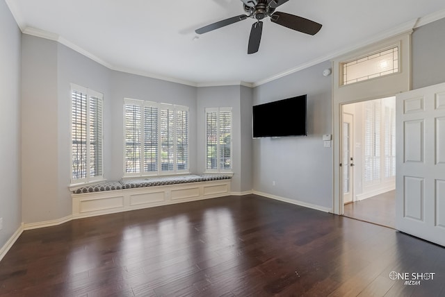 unfurnished living room featuring dark wood-type flooring, ornamental molding, ceiling fan, and plenty of natural light