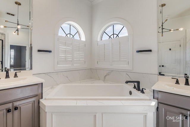 bathroom featuring vanity and a tub