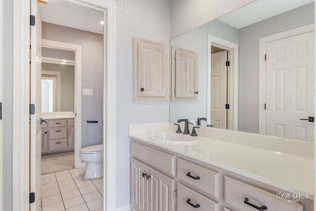 bathroom with tile patterned floors, vanity, and toilet