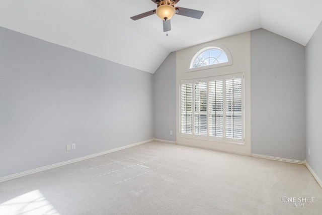 carpeted empty room with lofted ceiling and ceiling fan