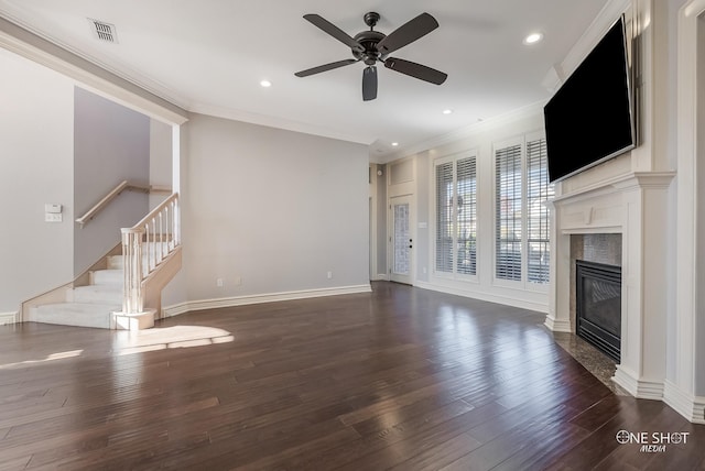 unfurnished living room featuring crown molding, dark hardwood / wood-style floors, ceiling fan, and a fireplace