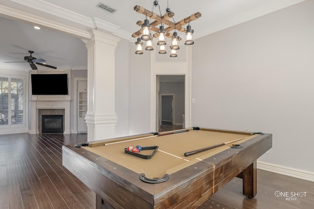 game room with dark wood-type flooring, ornamental molding, and decorative columns