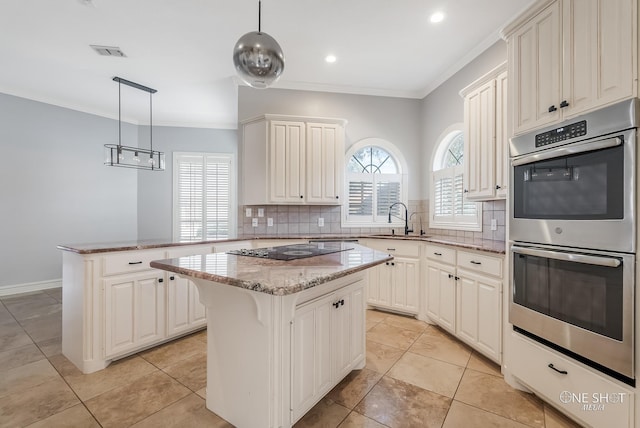 kitchen featuring black electric cooktop, hanging light fixtures, a center island, and stainless steel double oven