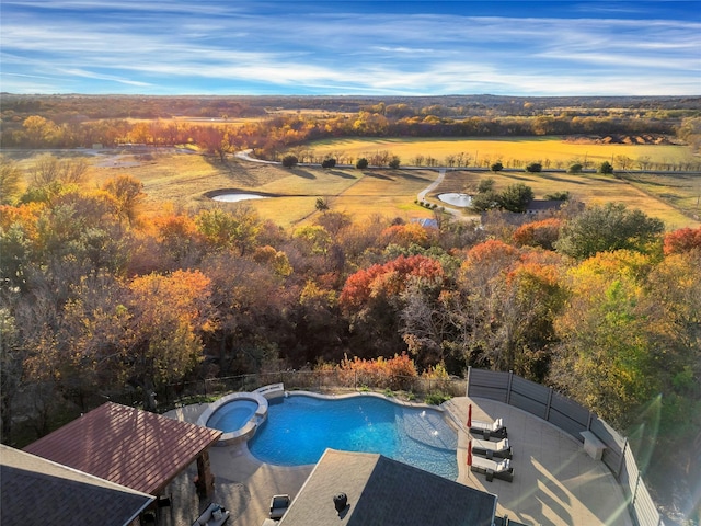 view of swimming pool featuring a rural view