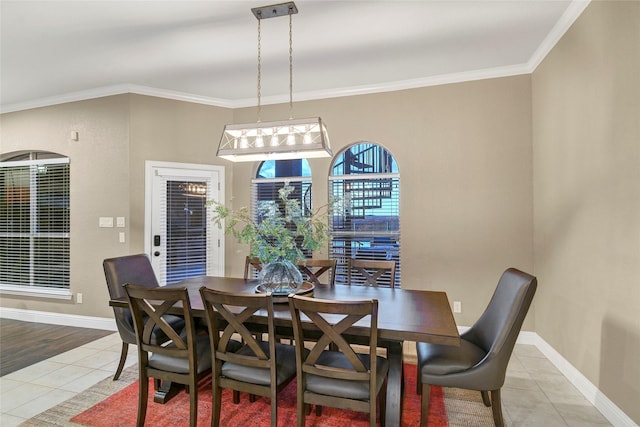 dining room with ornamental molding and light tile patterned floors