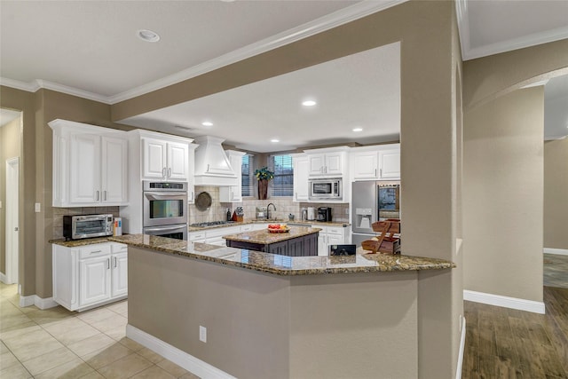 kitchen featuring white cabinetry, appliances with stainless steel finishes, and stone counters