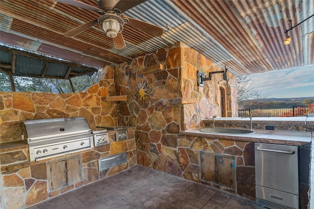 view of patio / terrace with ceiling fan, a grill, exterior kitchen, and sink