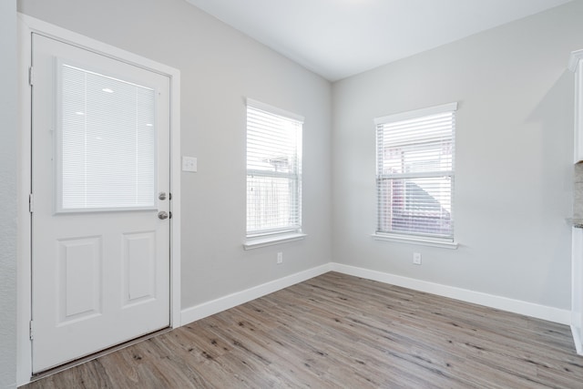 foyer entrance with light hardwood / wood-style floors