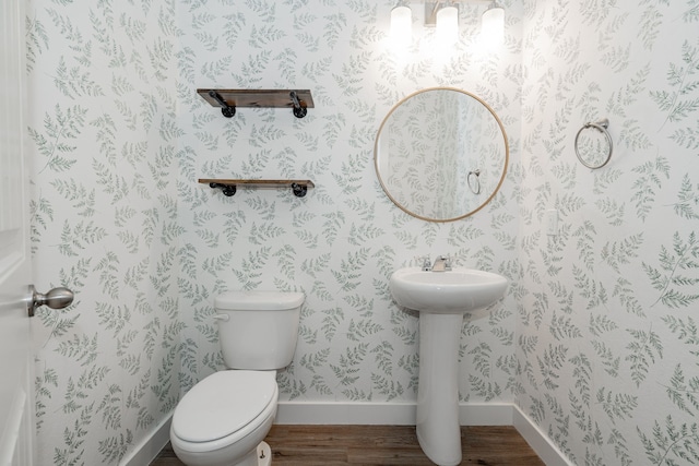 bathroom with toilet and hardwood / wood-style flooring