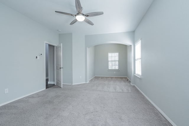 carpeted spare room featuring ceiling fan