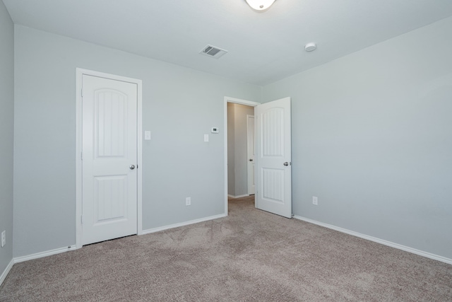 spare room with light carpet