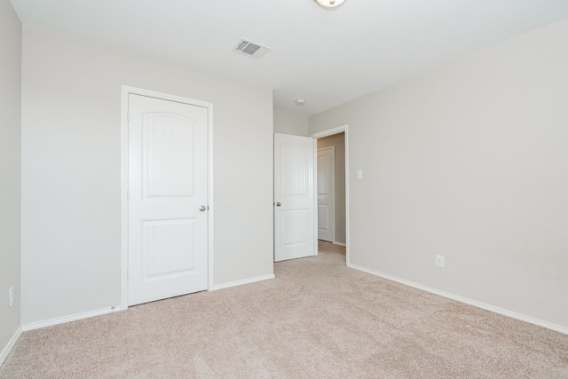 unfurnished bedroom featuring light carpet