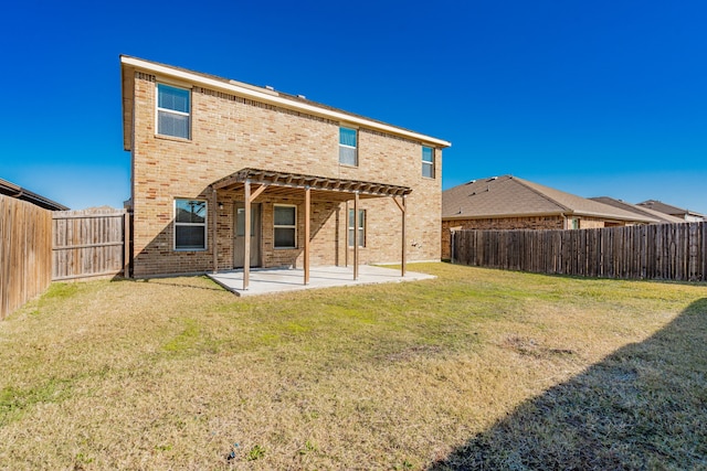 rear view of house with a pergola, a yard, and a patio area