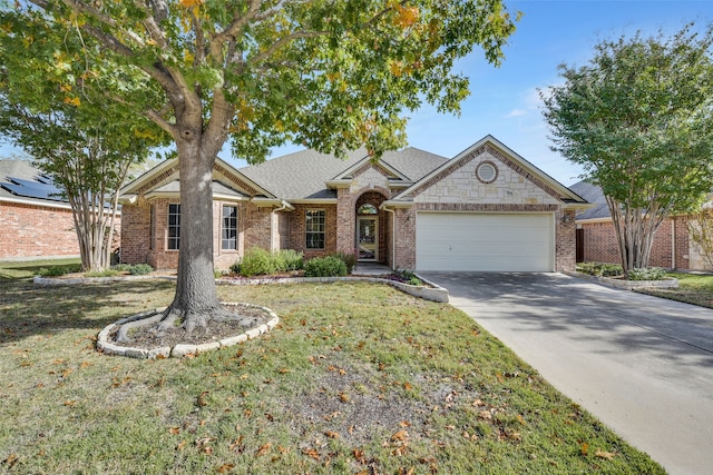 ranch-style home featuring a garage and a front lawn