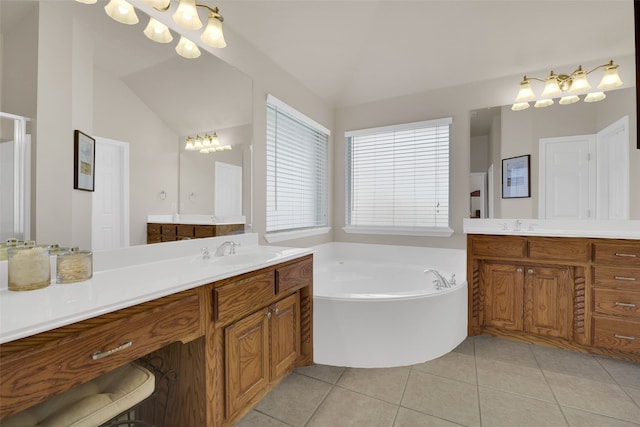 bathroom featuring tile patterned flooring, vanity, a washtub, and vaulted ceiling