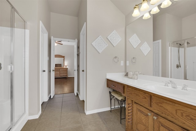 bathroom featuring ceiling fan, tile patterned flooring, vanity, and an enclosed shower