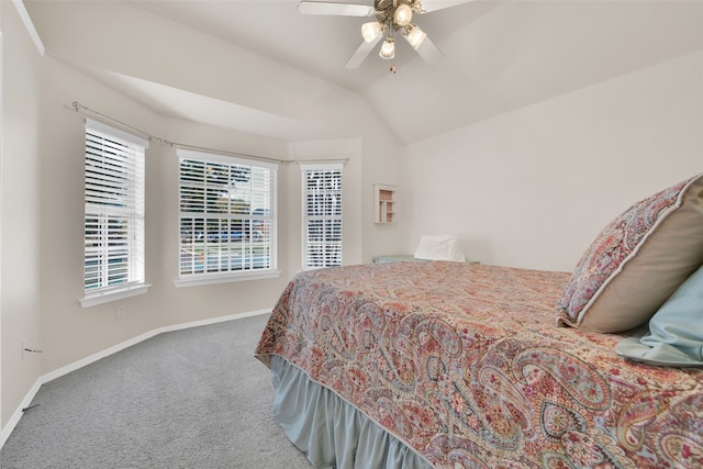 bedroom with multiple windows, carpet flooring, vaulted ceiling, and ceiling fan