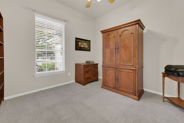 interior space featuring light colored carpet and ceiling fan