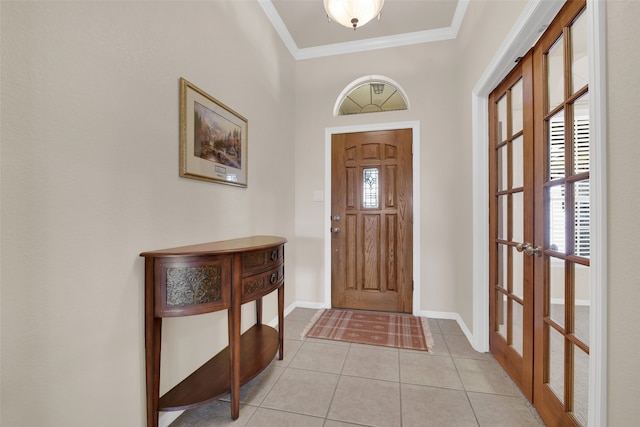 entryway with light tile patterned flooring, ornamental molding, and french doors