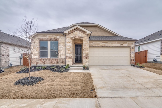 view of front facade with stone siding, roof with shingles, driveway, and an attached garage