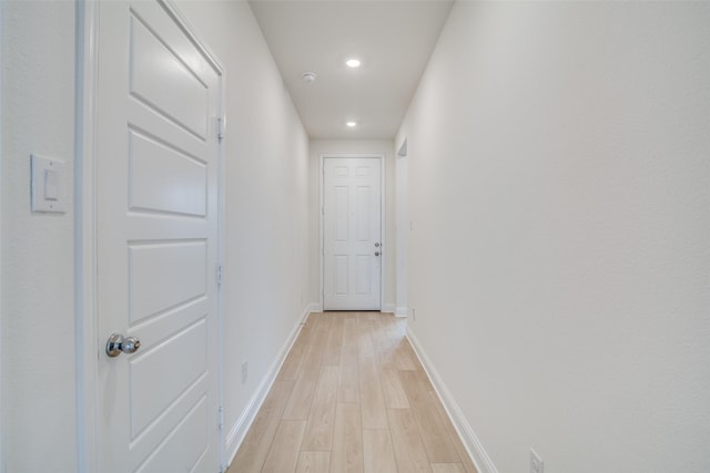 hallway with recessed lighting, light wood-style flooring, and baseboards