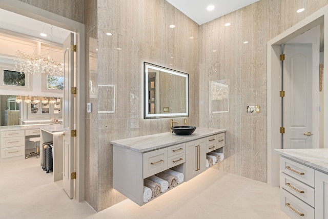 bathroom featuring tile patterned flooring, vanity, and tile walls