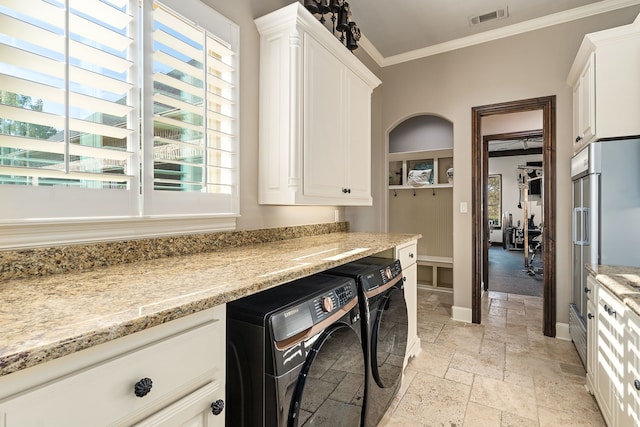 laundry room with washing machine and dryer and crown molding