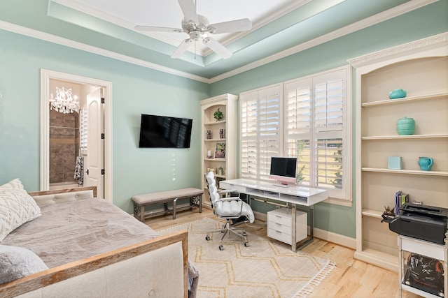 home office with hardwood / wood-style floors, ceiling fan with notable chandelier, a raised ceiling, and crown molding