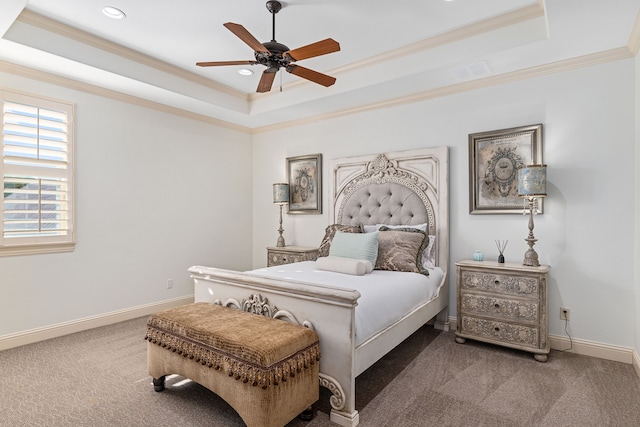 bedroom featuring carpet flooring, a tray ceiling, ceiling fan, and ornamental molding