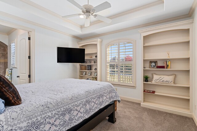 carpeted bedroom featuring a raised ceiling, ceiling fan, and ornamental molding