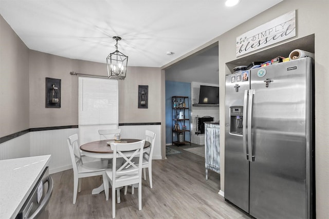 dining space featuring an inviting chandelier and light hardwood / wood-style floors