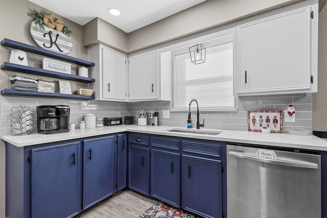 kitchen with dishwasher, light wood-type flooring, blue cabinetry, white cabinets, and sink