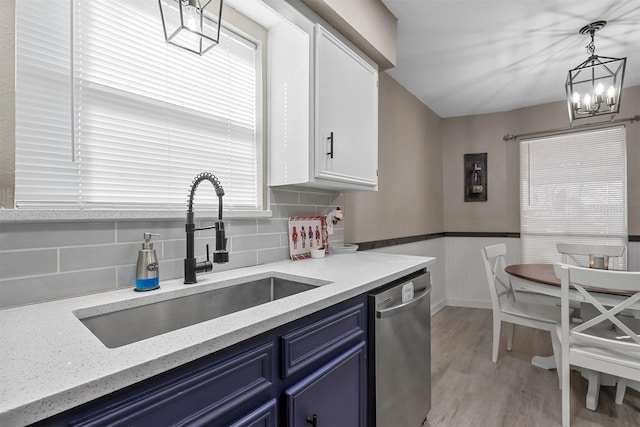 kitchen with dishwasher, pendant lighting, blue cabinets, white cabinets, and sink