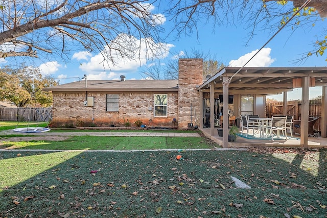 back of house featuring a yard and a patio